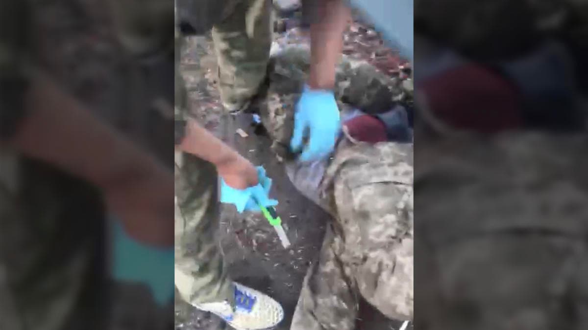 Russian soldiers castrating Ukrainian prisoner of war